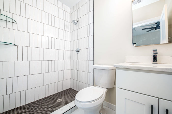 white bathroom with dark backsplash